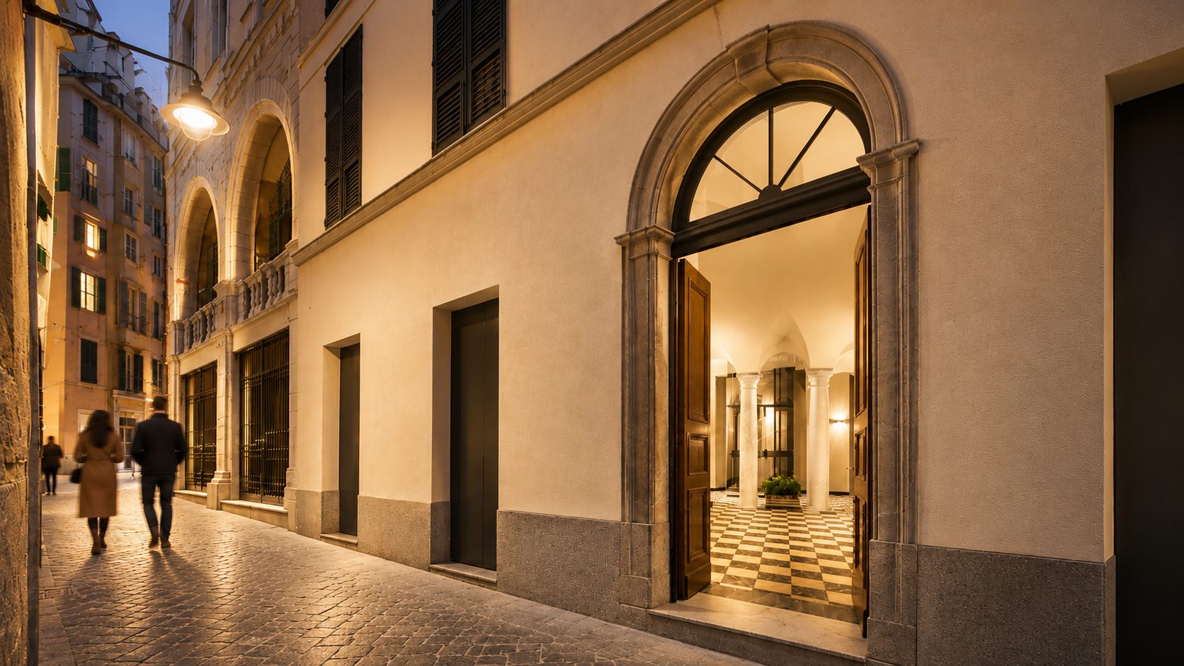 Rendering del portale di Giustiniani 19 illuminato di sera, nel vicolo del centro storico di Genova